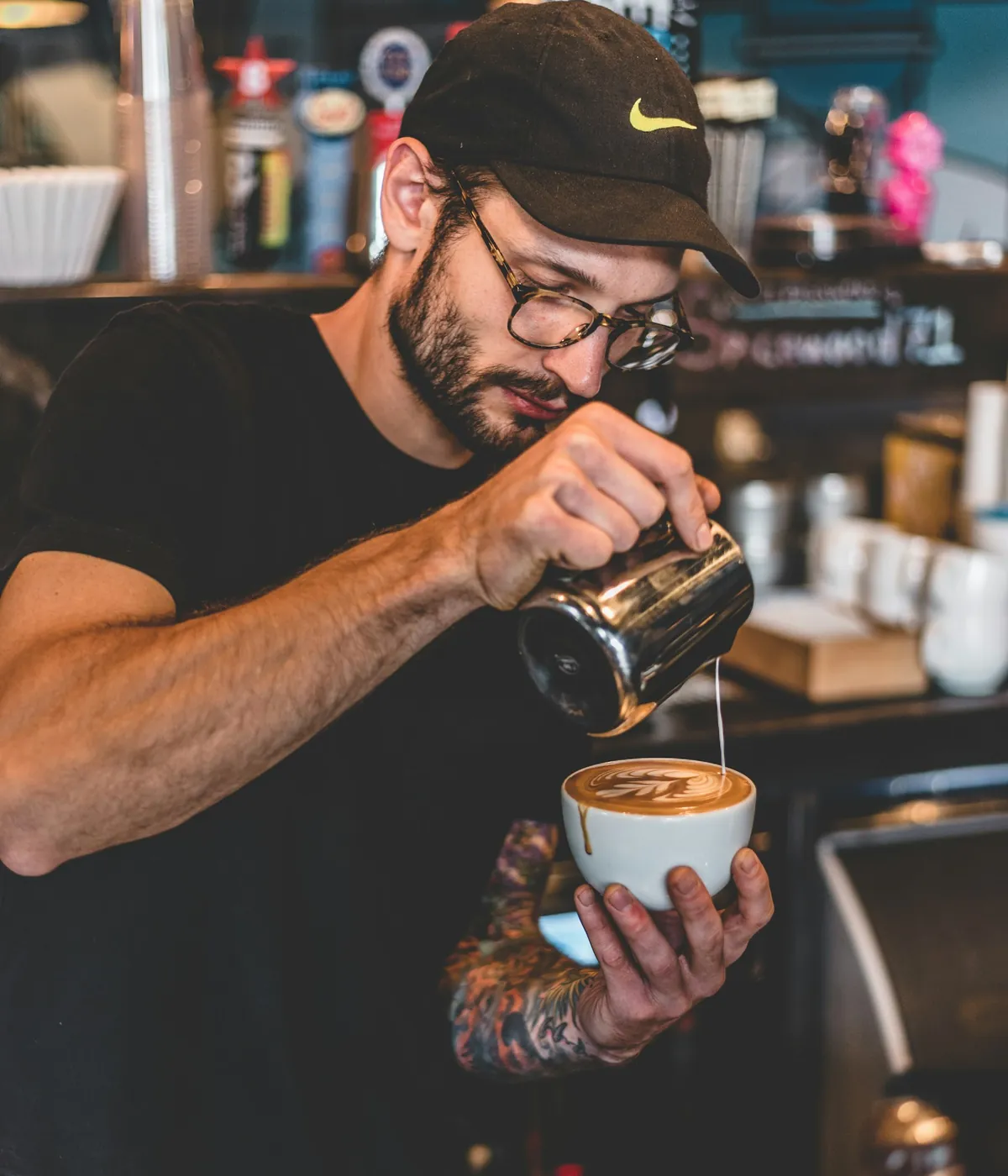 A café professional preparing coffee at the counter